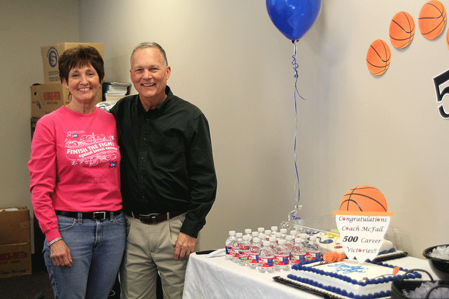 Standing+by+his+wife%2C+head+girls+basketball+coach+John+McFall%2C+along+with+members+of+the+team%2C+celebrate+his+500th+win.