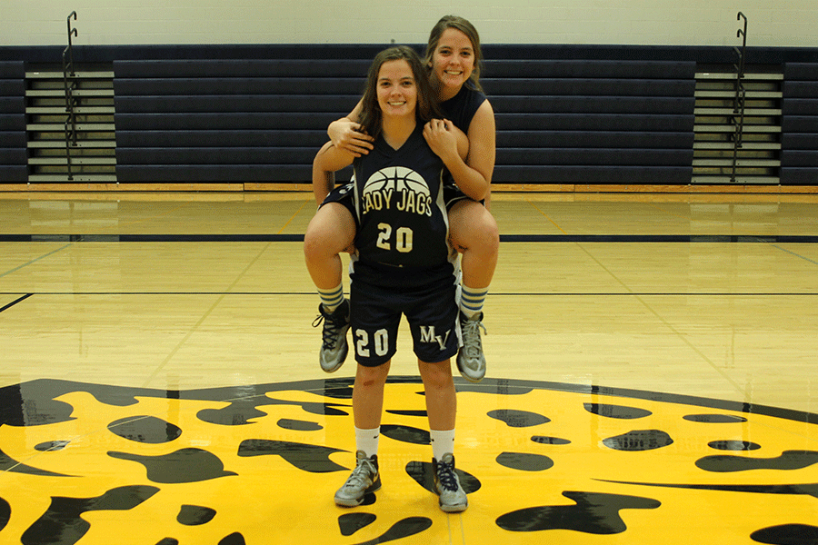 Seniors Lexie and Lacie pose together in the gym, a common place for them both to be due to similar interests.