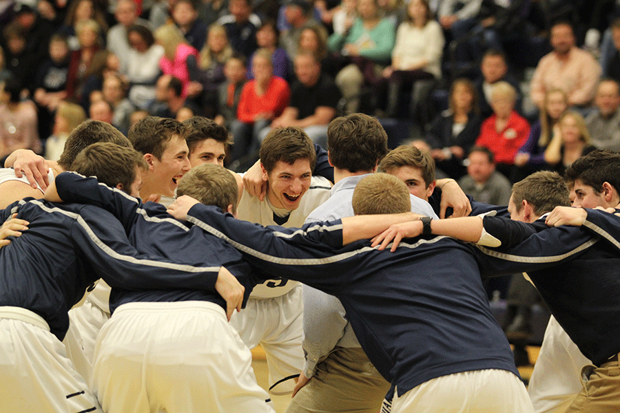 Junior Clayton Holmberg chants during a team huddle before the boys basketball game against Tonganoxie on Friday, Jan. 16.
