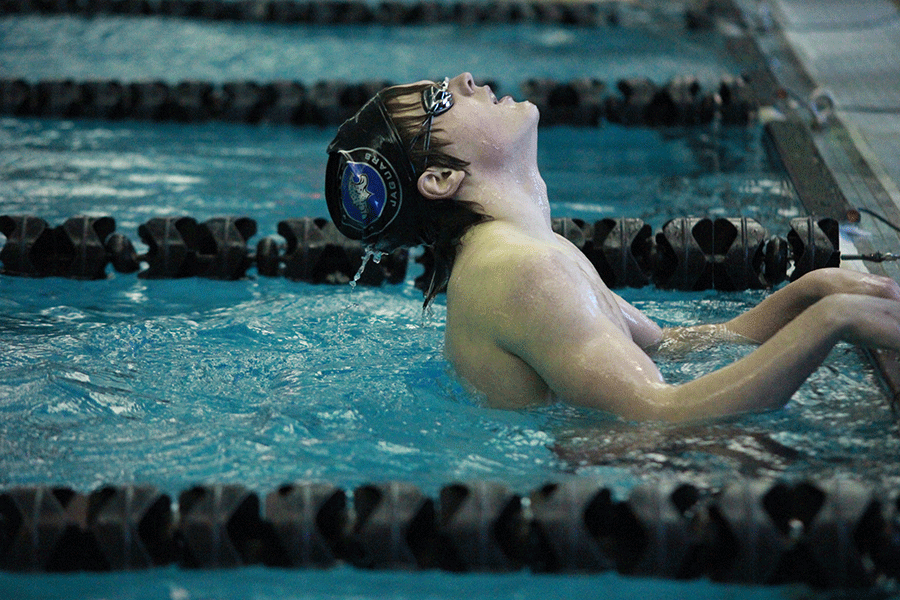 Sophomore Spencer Smith relaxes after his freestyle heat during the swim meet at Turner High School on Monday Jan. 12.