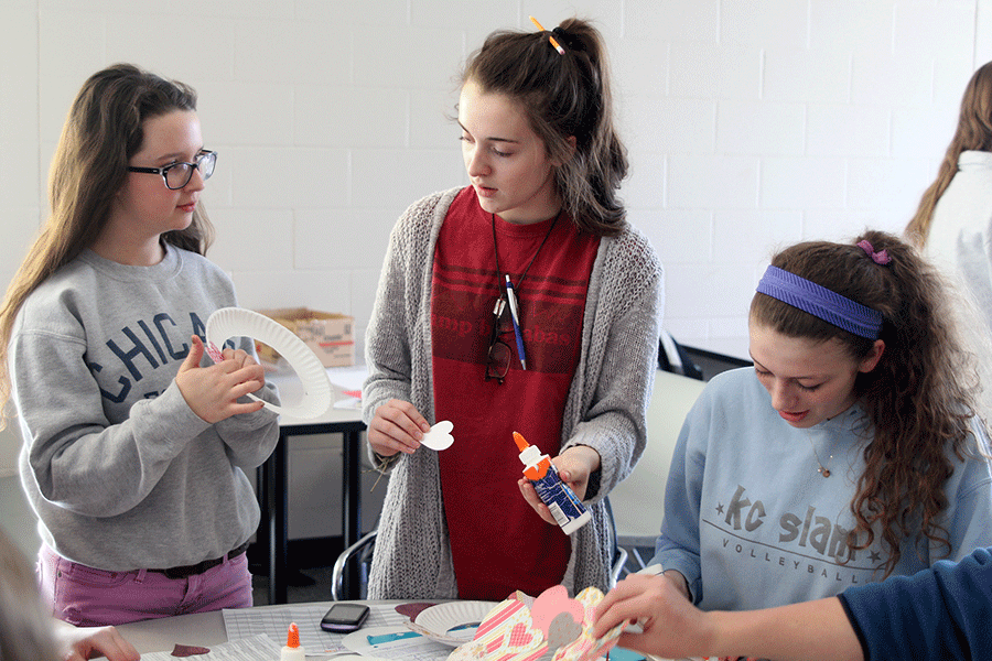 Working together, sophomores Melissa Kelley, Savannah Chappell and Maggie Bogart create decorative wreaths during seminar on Friday, Jan. 23.