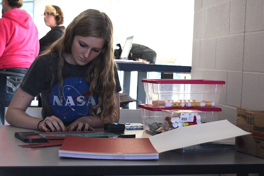 Sophomore Allison Saab creates Valentines Day decorations for Childrens Mercy Hospital during an MV Outreach meeting on Friday, Jan. 23.