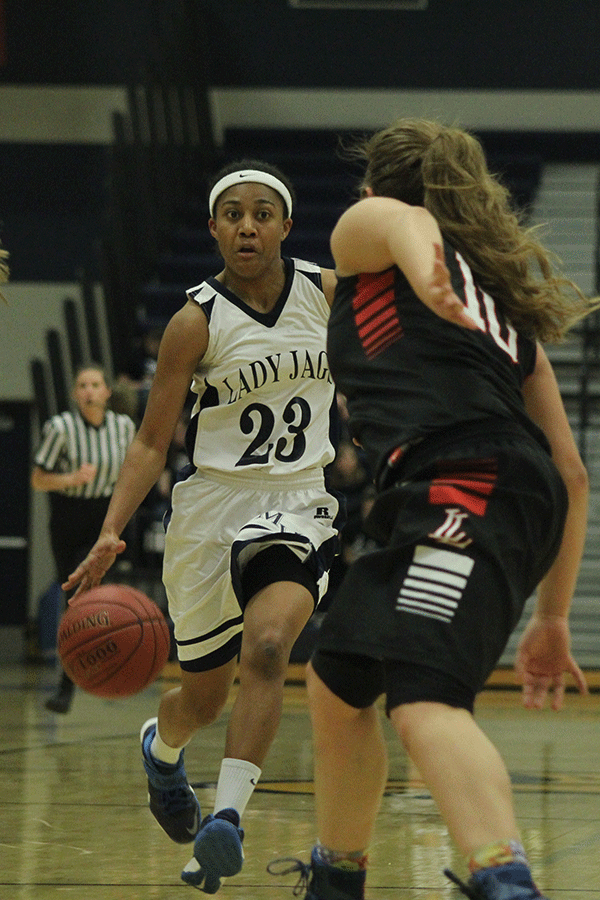 Senior Jabria Leggett gains possession of the ball and dribbles past her opponent.