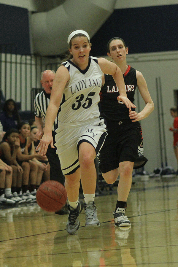 Senior Lacie Myers dribbles down the court after gaining possession of the ball.