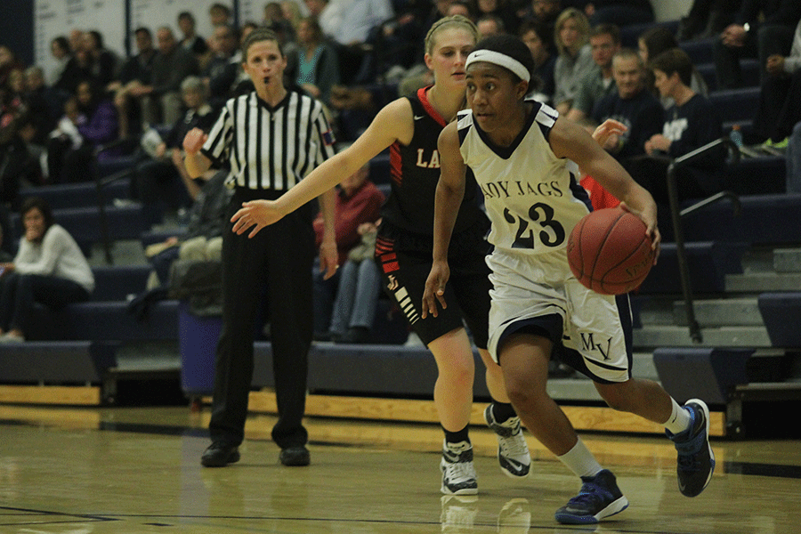 Senior Jabria Leggett dribbles past her opponent.