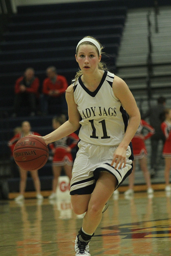 Senior Savannah Rudicel dribbles the basketball down the court.