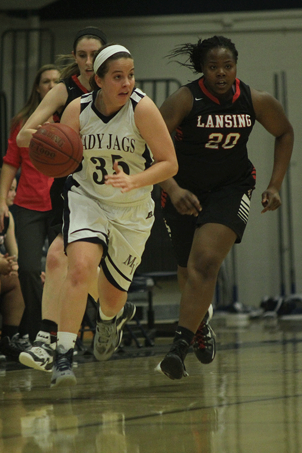 Senior Lacie Myers dribbles the ball down the court towards the basket.