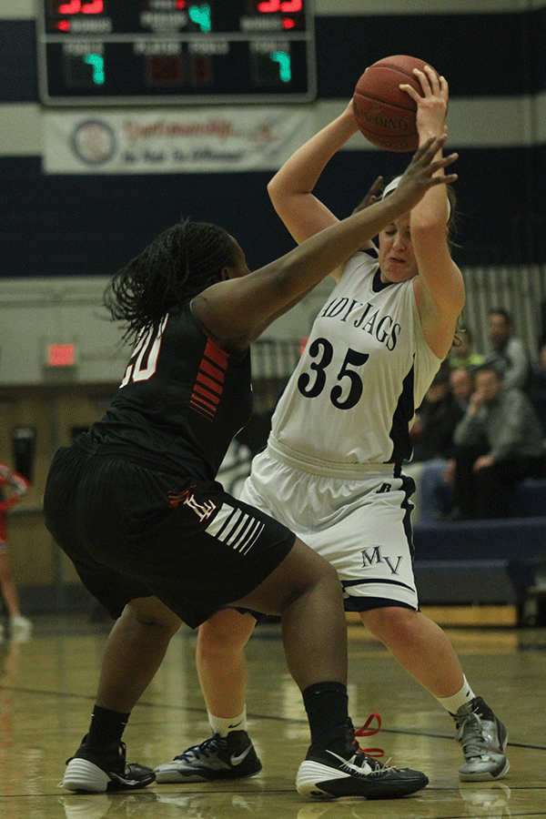 Senior Lacie Myers attempts to dodge an incoming player trying to block her pass.