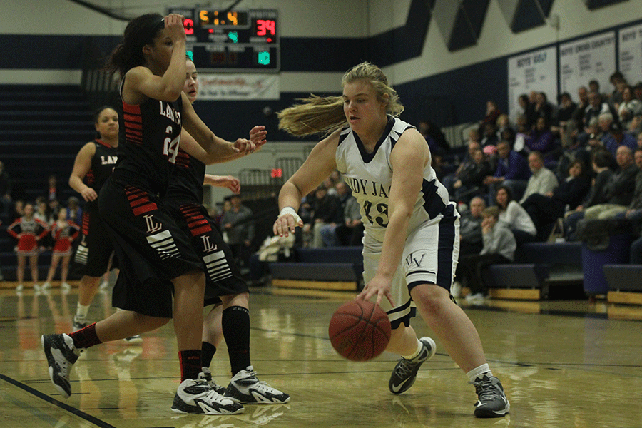 Sophomore Ashlyn Hendrix dribbles the ball past her opponent.