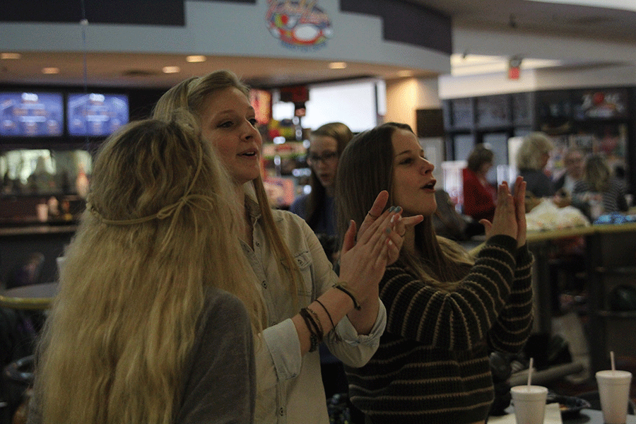 Sophomores Ally Saab and Kristen Schau applaude other students while they are bowling.