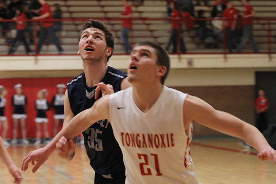 Junior Clayton Holmberg looks to get a rebound during the basketball game against the Tonganoxie Chieftans on Tuesday, Feb. 24. The Jaguars defeated the Chieftans 60-46.