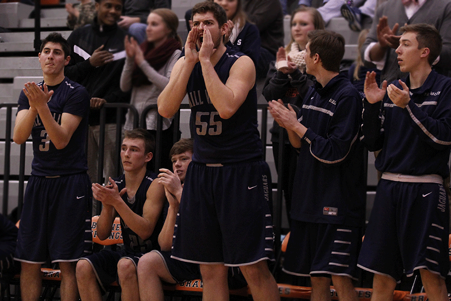 Junior Tanner Jenkins cheers after two consecutive three pointers by junior Jaison Widmer during the basketball game against the Bonner Springs Braves on Tuesday, Feb. 17. The Jaguars defeated the Braves 49-43.