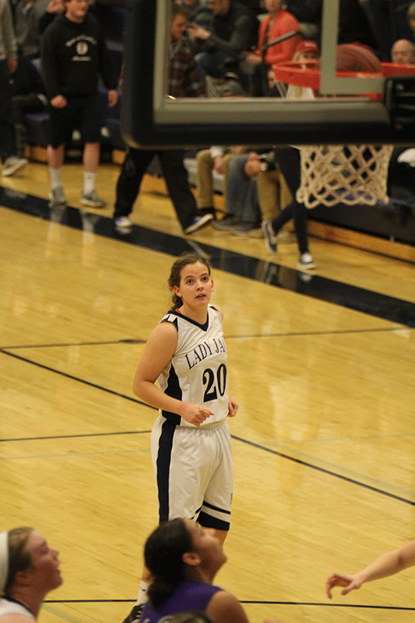 Senior Lexie Myers watches as the ball goes through the hoop.