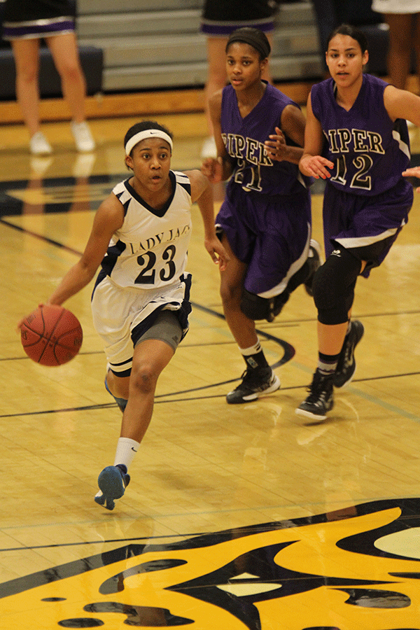 Senior Jabria Leggett dribbles past defensive players.