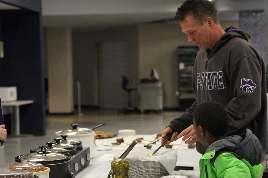 A+father+and+son+scooped+their+bowls+of+chili+and+the+annual+Chili+Bowl+Sale+on+Friday%2C+Feb.+20+to+support+NAHS.