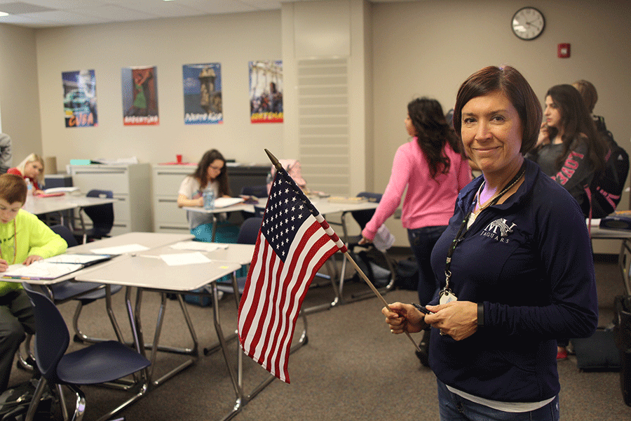 World language teacher Edith Paredes stands in her classroom with an American flag on Wednesday, Feb. 11.