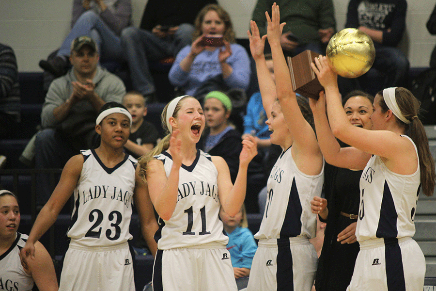 After the Lady Jags beat the Basehor-Linwood Bobcats 47-36, the seniors on the team celebrate by holding up the Kaw Valley League Championship trophy on Friday, Feb. 27.