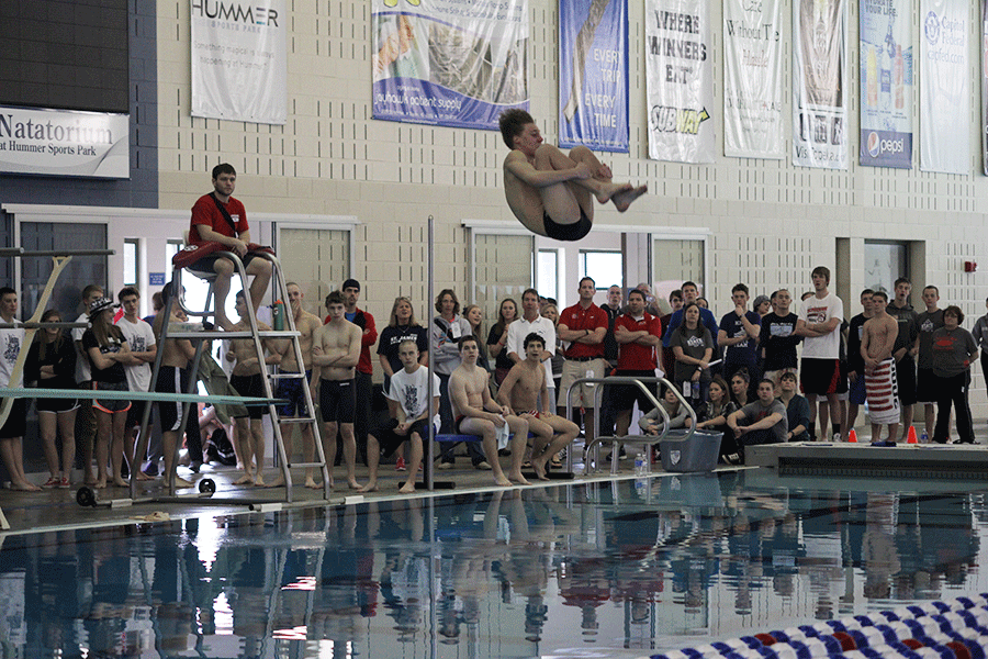 Sophomore Mitch Willoughby performs a forward two-and-a-half somersault tuck at the boys state swim meet on Saturday, Feb. 21. Willoughby finished third in 1A-5A state diving.