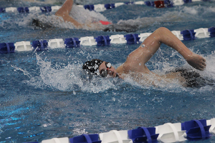 Sophomore Garrison Fangman competes in his led of the 200 yard freestyle relay at the boys state swim meet on Saturday, Feb. 21.