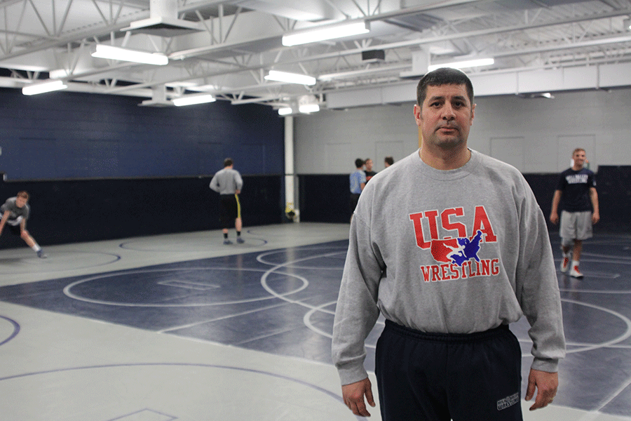 Wrestling coach Travis Keal stands in the wrestling room on Tuesday, Feb. 10. Keal has led the wrestling programs to constant success since its beginning.