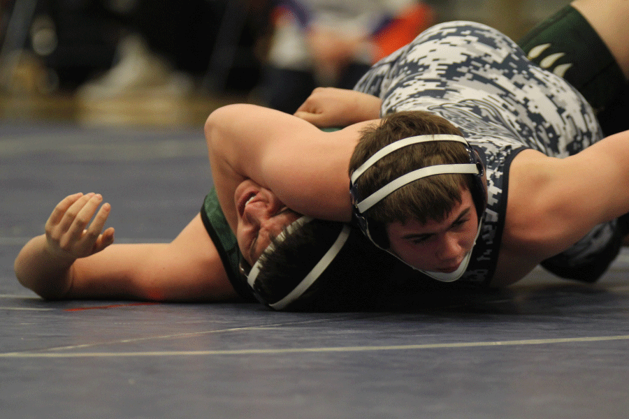 Wrestling on senior night, senior Nathan Anderson pins his opponent on Thursday, Feb. 5.