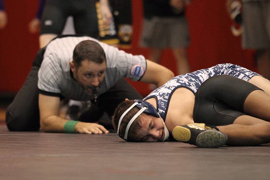 Pinning his opponent, sophomore Dylan Gowin competes at the 5A Regional Wrestling tournament at Blue Valley West High School on Saturday, Feb. 21. Gowin finished in 1st place for the 106 weight class.