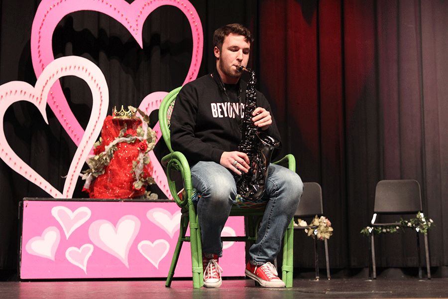 Between segments, senior Clayton Kistner plays the saxophone to entertain the audience.