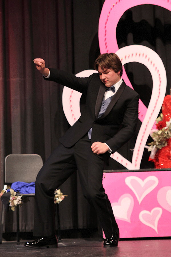 Junior Tyler Shurley strikes a pose while modeling his evening wear during the pageant.