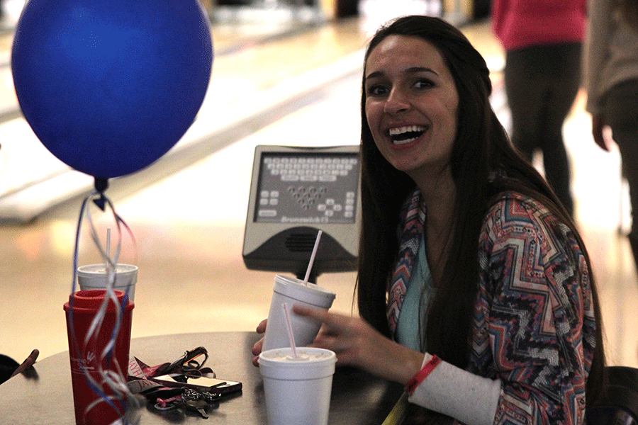 Junior Maddie Gerber smiles while bowling with the club MV Outreach.