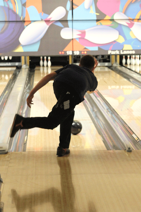 Junior Jordan Laluk rolls his ball down the lane in order to knock down the remaining three pins.