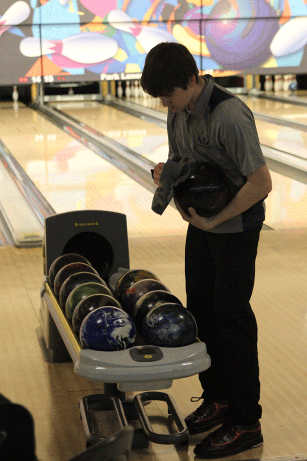 Junior Jordan Laluk cleans his bowling ball before he bowls.