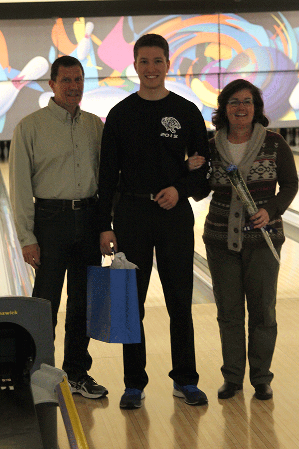 Senior Cody Deas stands with his parents.