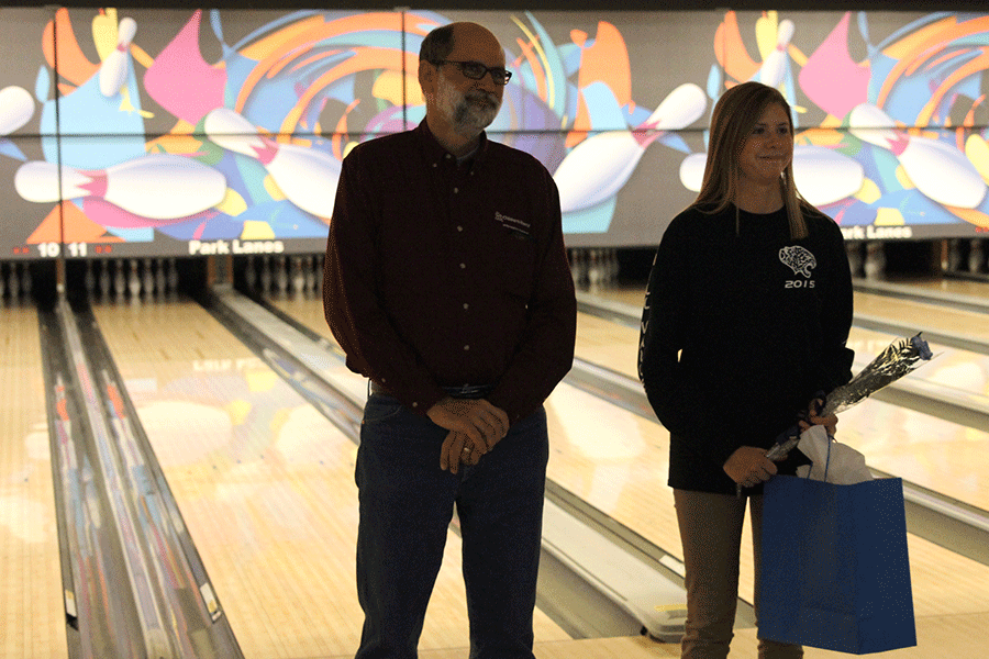 Senior Maridee Weber stands with her father.