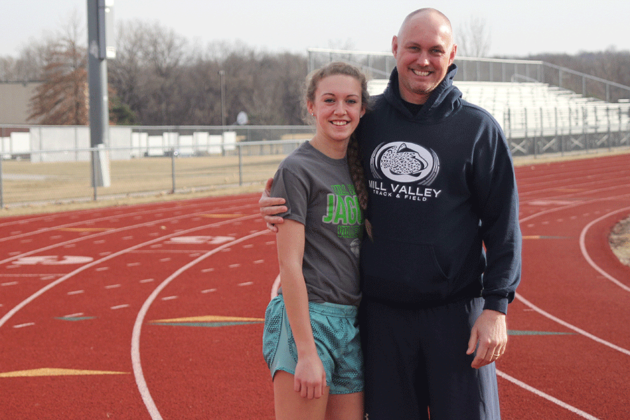 Sophomore Morgan Thomas stands next to her father, coach Eric Thomas, on the track on Friday, Jan. 30.