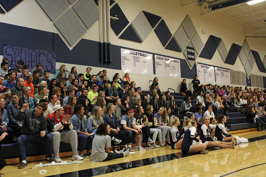 Alongside fellow classmates, senior Libby DeWitte watches the Winter Homecoming pep assembly on Friday, Jan. 16. “I thought [the lack of seniors] was sad,” DeWitte said. “The year isn’t over yet and we’re already splitting up and losing school spirit.”