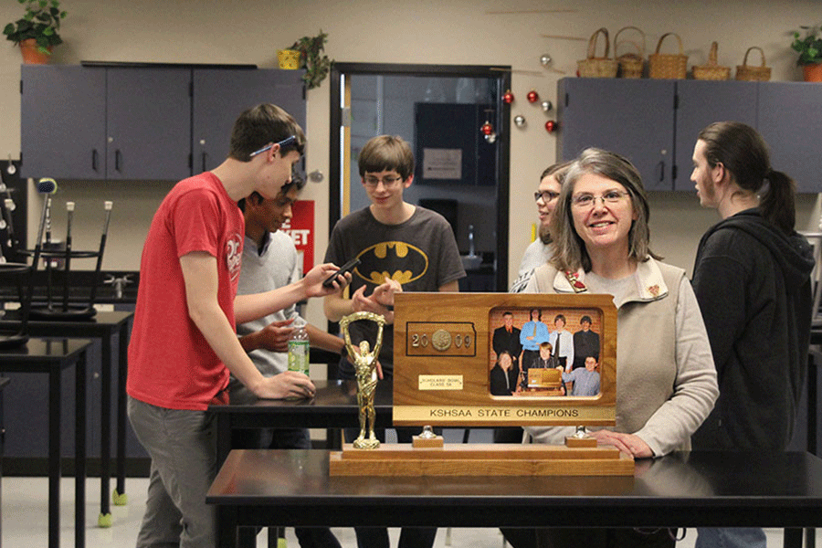 Quiz Bowl coach Mary Beth Mattingly stands with her 2009 Quiz Bowl state championship trophy on Wednesday, Feb. 11.