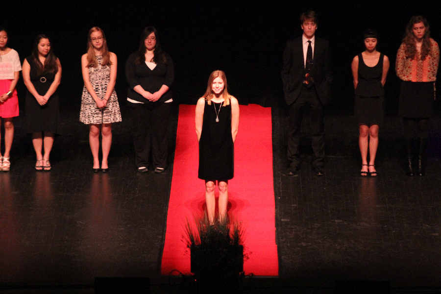 Waiting at the end of the red carpet while images of her portfolio play overhead, senior Maridee Weber waits to see if she won a scholarship. 