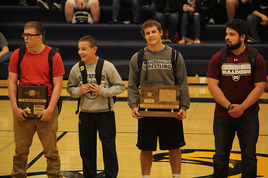 Junior Peyton Bendure, frehsman Dylan Gowin, junior Seth Burnett and senior Sebastian Uriarte are recognized with the rest of the wrestling team.