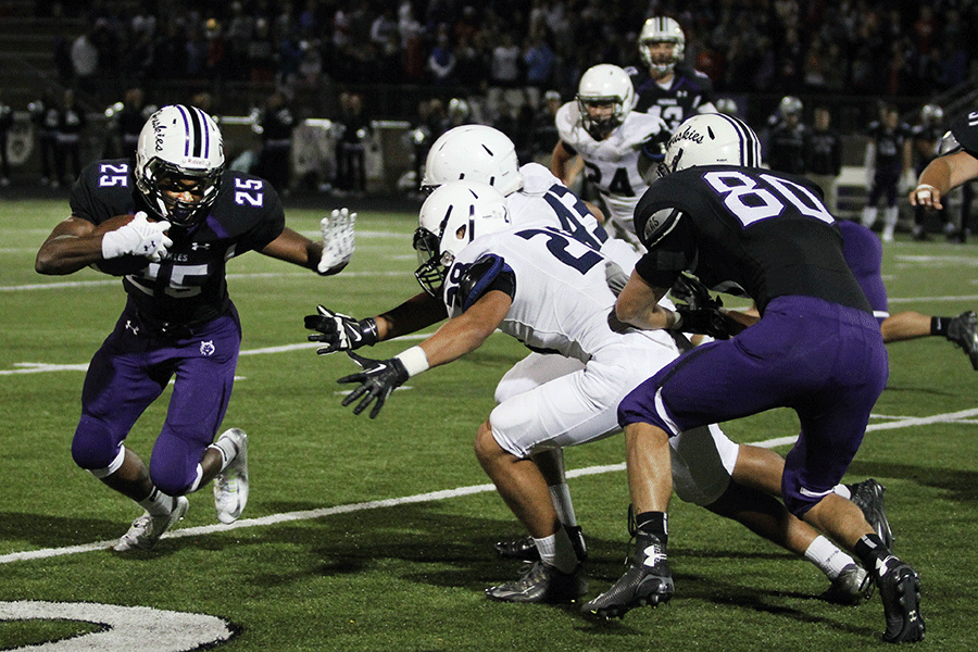 Senior Bryan Burnett and junior Hersimeran Auijla attempt to block a Blue Valley Northwest player on Friday, Sept. 11.