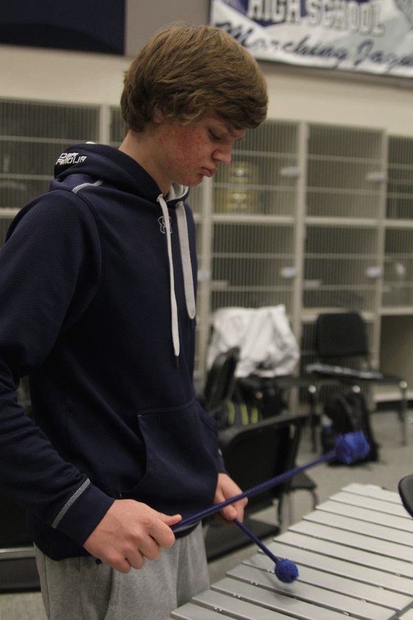 Junior Mitch Cowan plays the xylophone in Blue Band on Friday, Feb. 27.