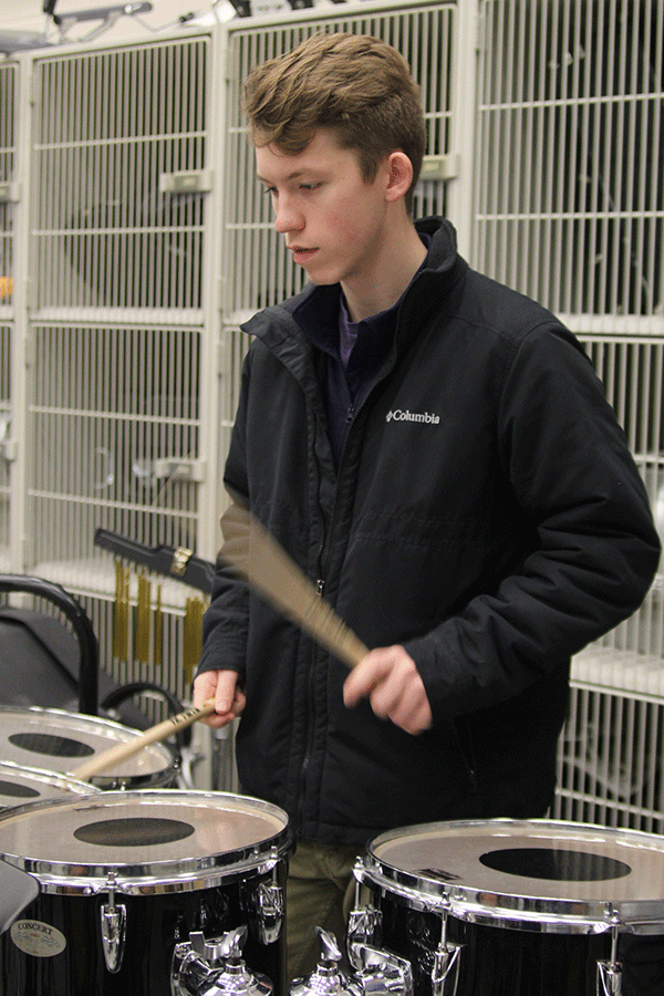 While concentrating on the beat, junior Cole Griggs plays the drums on Friday, Feb. 27. “I feel like being able to express your way on drums is a lot different than any other instrument,” Griggs said.