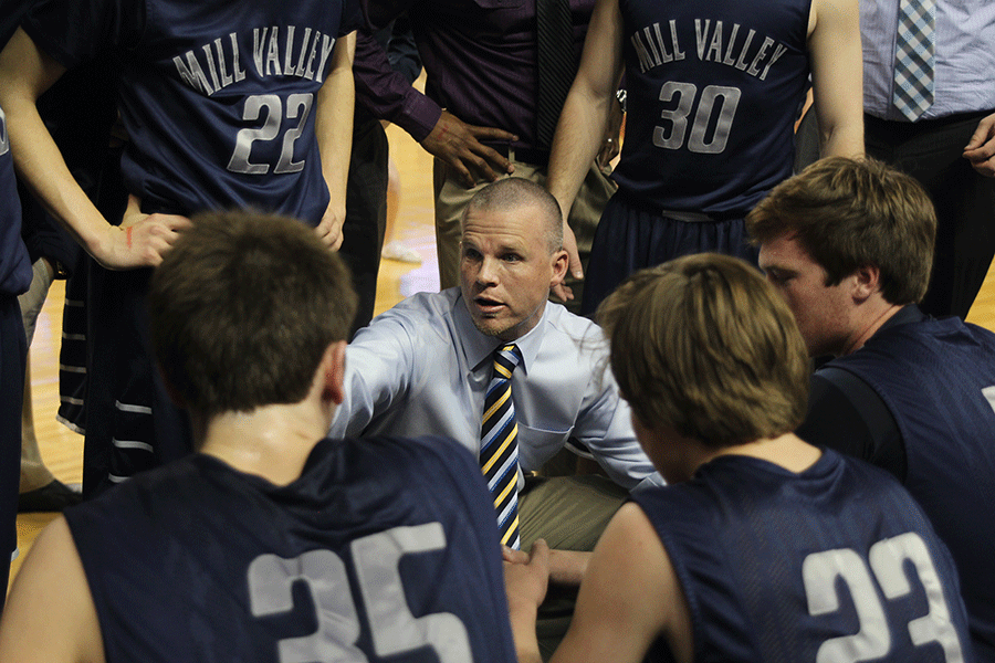 After a comeback in the third quarter, varsity boys basketball coach Mike Bennett tells the team the play.