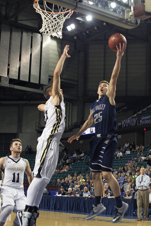 Avoiding the defense, junior Jaison Widmer goes up for a layup.