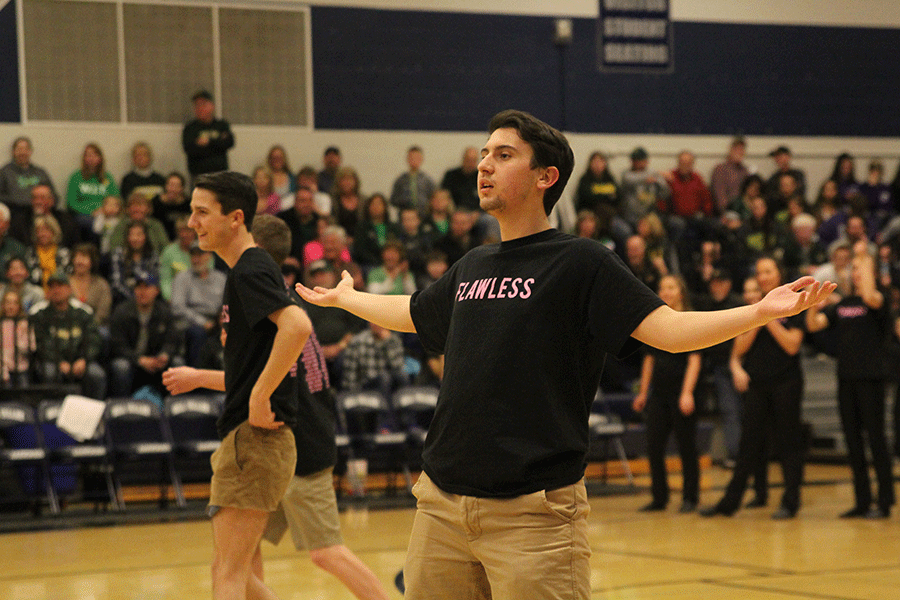 After the music cuts off at the beginning of the dance, senior Austin Moores holds his arms up after already starting.