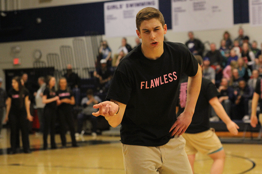 At the start of the dance senior Chase Battes holds out his hand.
