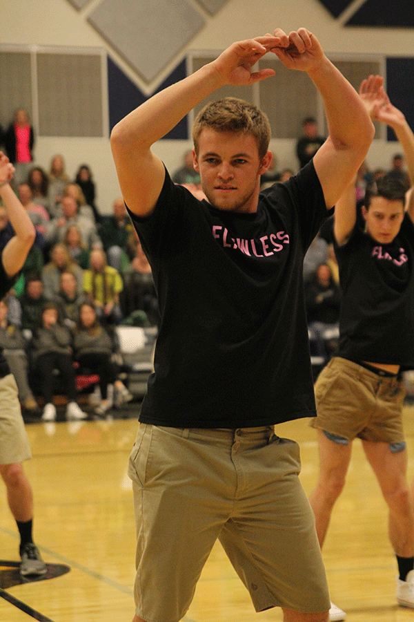 Senior Zach Hanna holds his hands above his head.