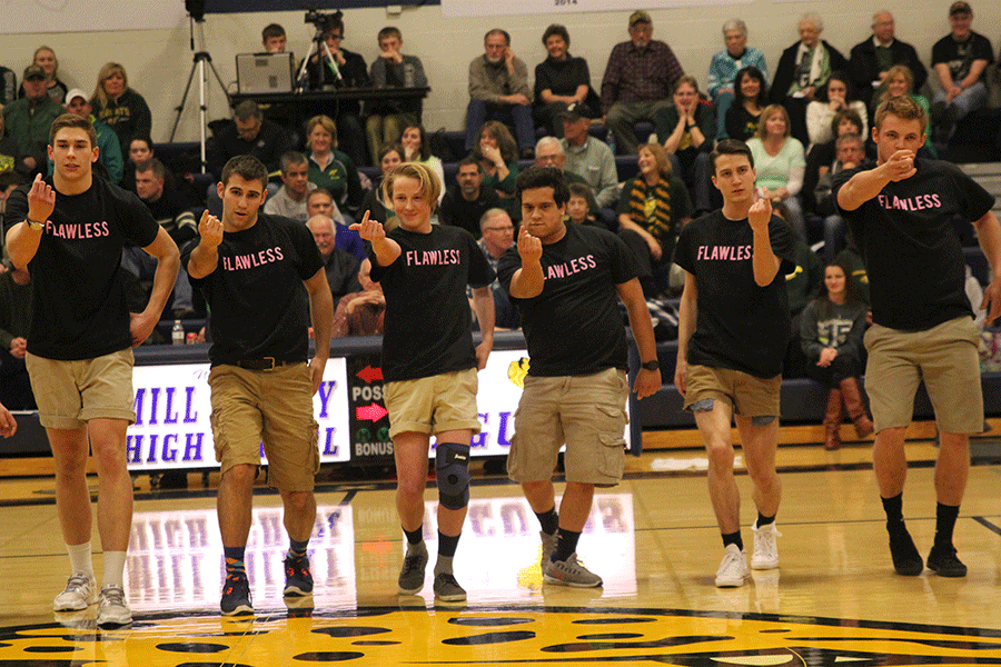 Encouraging the audience to come toward them, a group of senior Silver Studs walk toward the crowd.