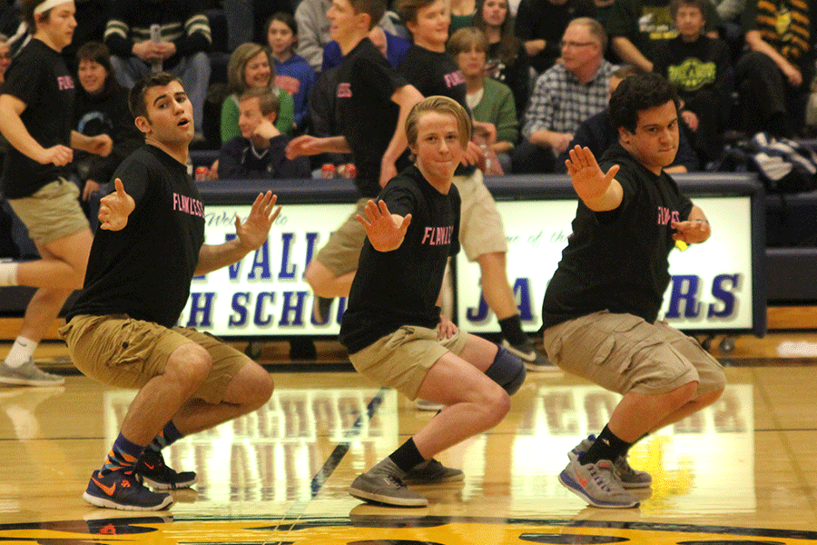 With hands out seniors Eli Stewart, Spencer Adams, and Adam Segura,move toward the crowd.