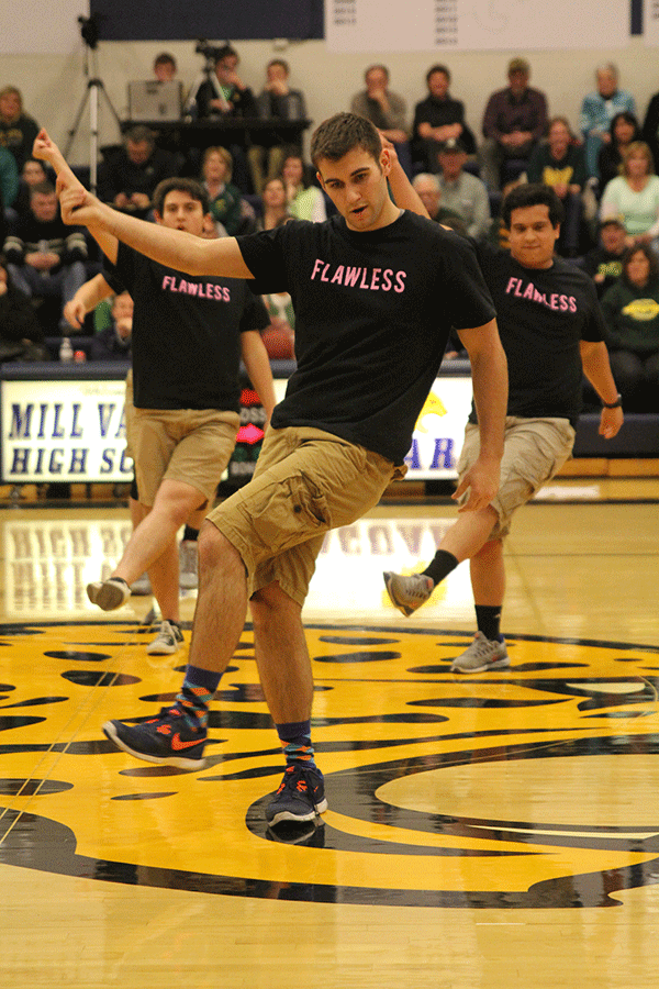 While kicking his foot, senior Eli Stewart snaps his fingers.