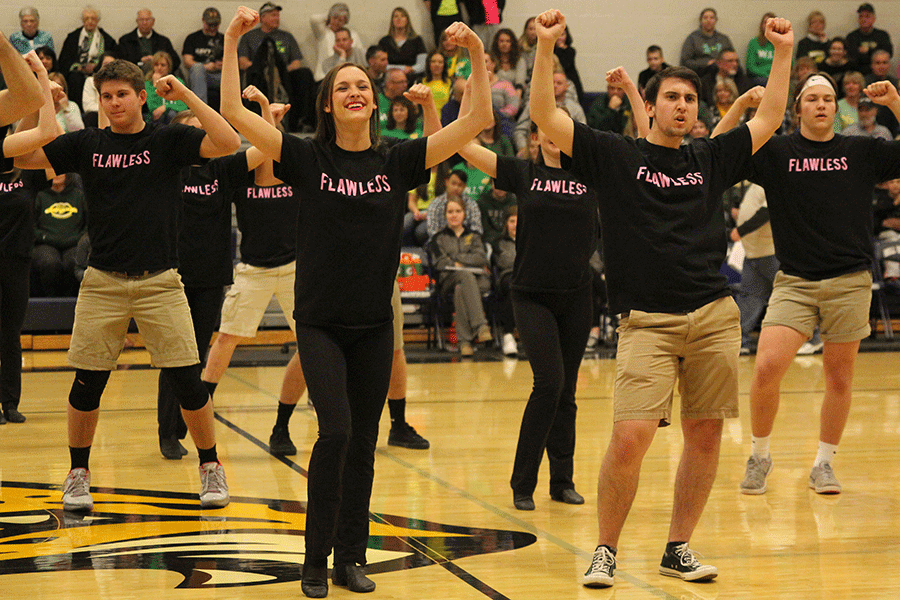 Seniors Maci Rouse and Austin Moores hold up their arms to show off their muscles.